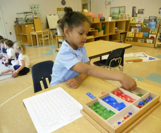 Girl in Montessori school showing how Montessori works.