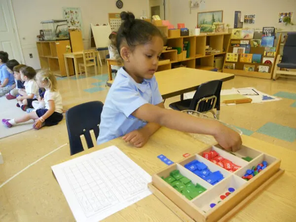 Girl in Montessori school showing how Montessori works.