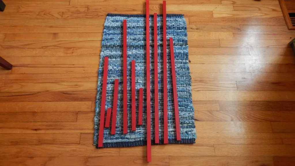 DIY Montessori Red Rods on rug.