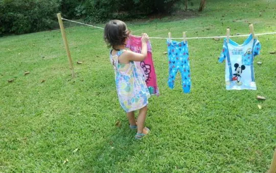 child hanging laundry a practical life activity.