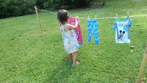 child hanging laundry a practical life activity.