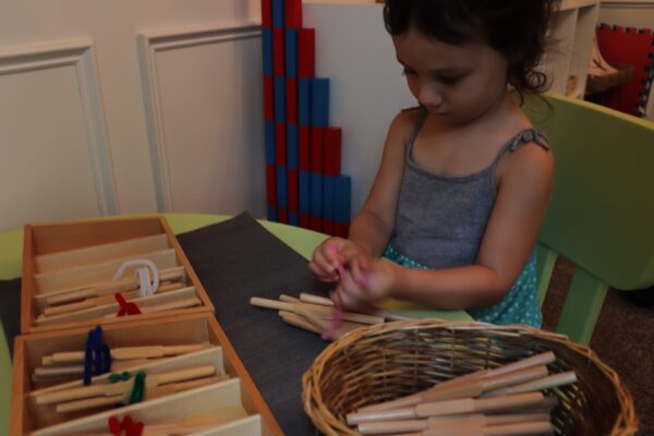 child using Montessori spindle boxes.
