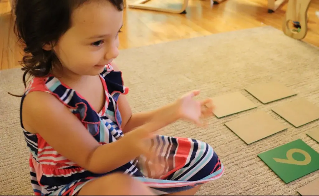 child playing zero game with montessori math materials.ri