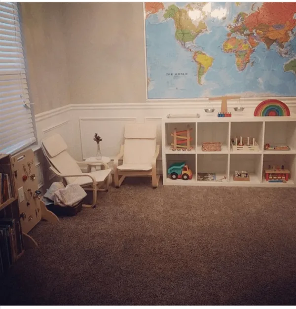 a decluttered play space for kids with open shelves and child-sized furniture is one way How To Get Started With Montessori in your own home.