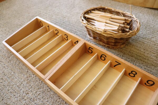 the montessori spindle boxes numbered 0-9, with spindles in basket.