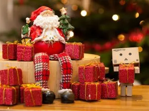 small santa with tiny red presents. Montessori christmas gift guide.