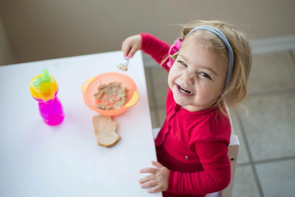 Toddler feeding herself.