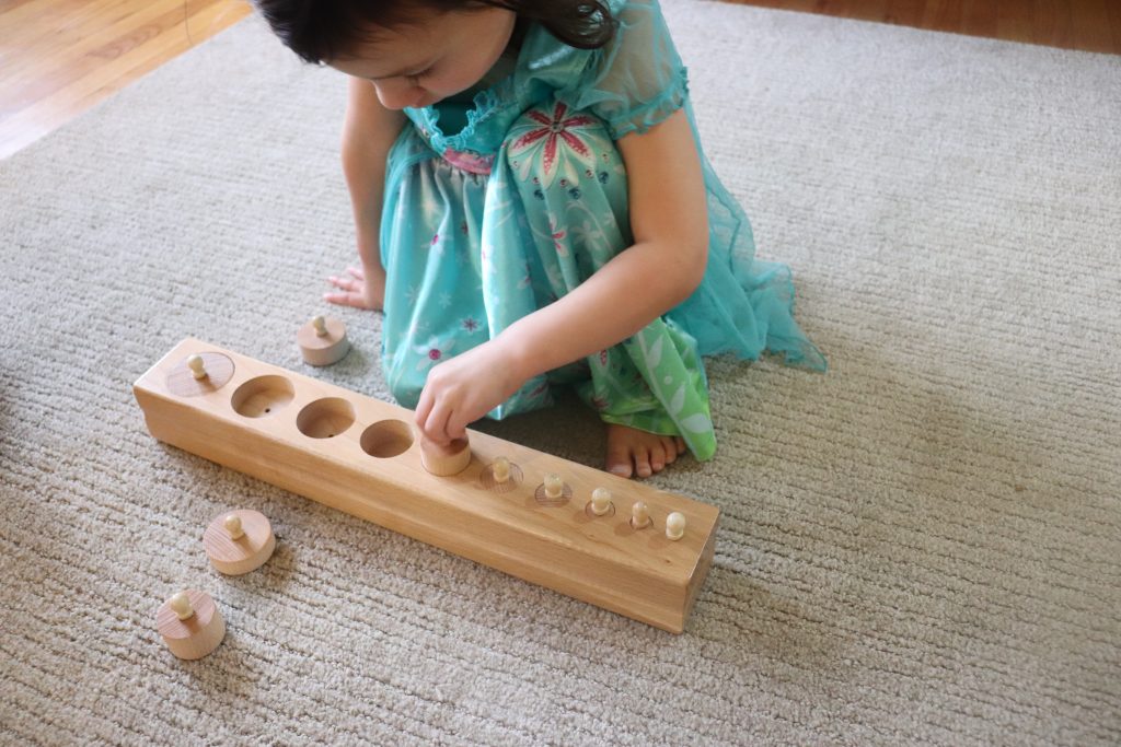 Child working with Knobbed Cylinders, with built in control of error.