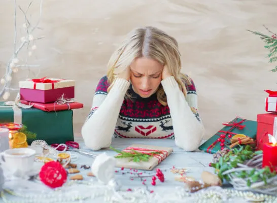 woman surrounded by gifts, stressed about how to accept gifts you don't want.