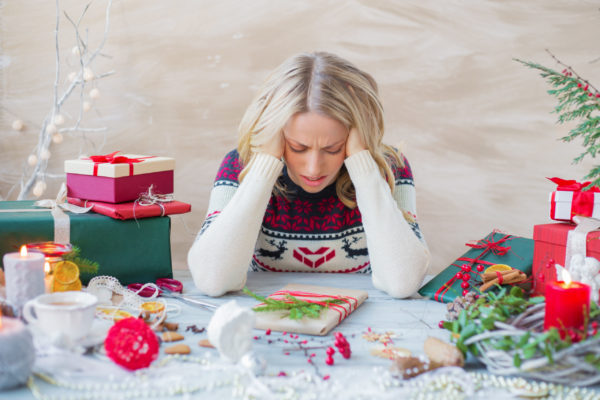 woman surrounded by gifts, stressed about how to accept gifts you don't want.