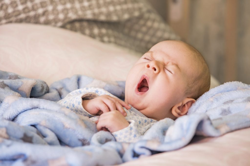 yawning sleepy baby.Gentle parenting and sleep training.