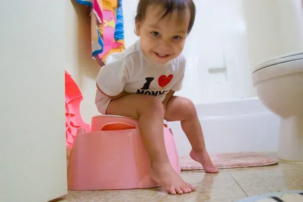 child on a potty chair. When can kids wipe their own butts?