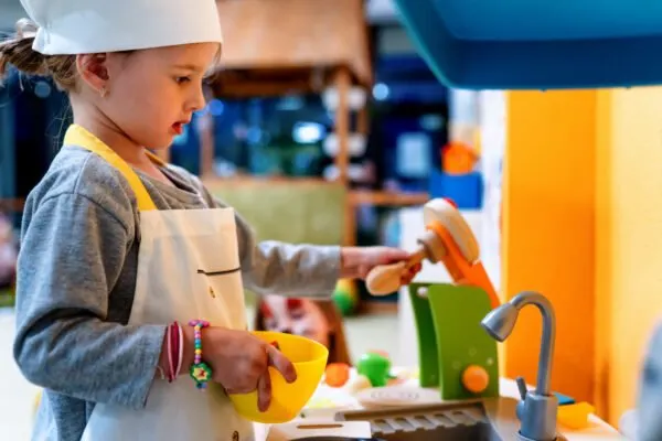 child in montessori play kitchen.