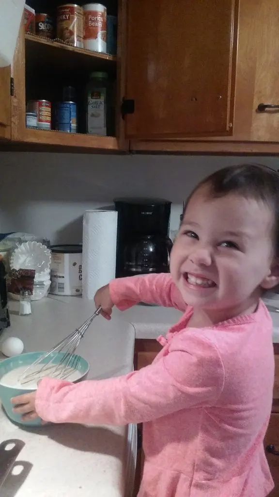 child helping in kitchen for quality time to prevent whining for attention