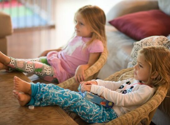 two girls watching quality tv programs for young children.