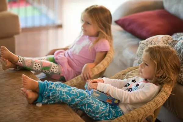 two girls watching quality tv programs for young children.
