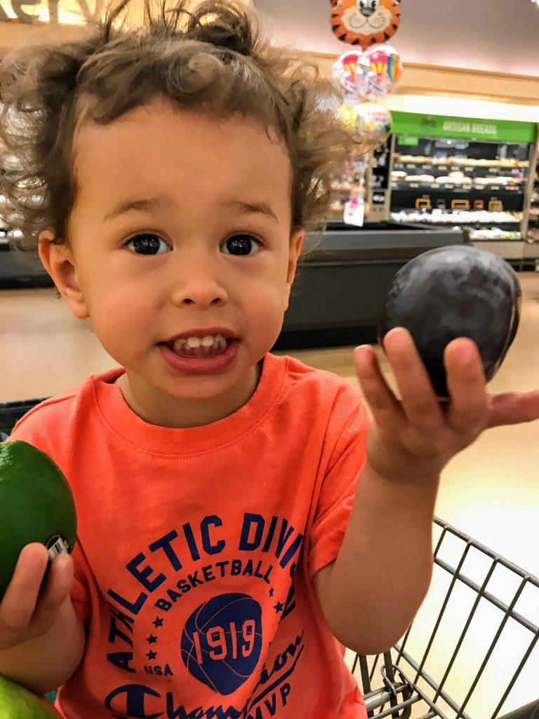 Toddler helping parent shop