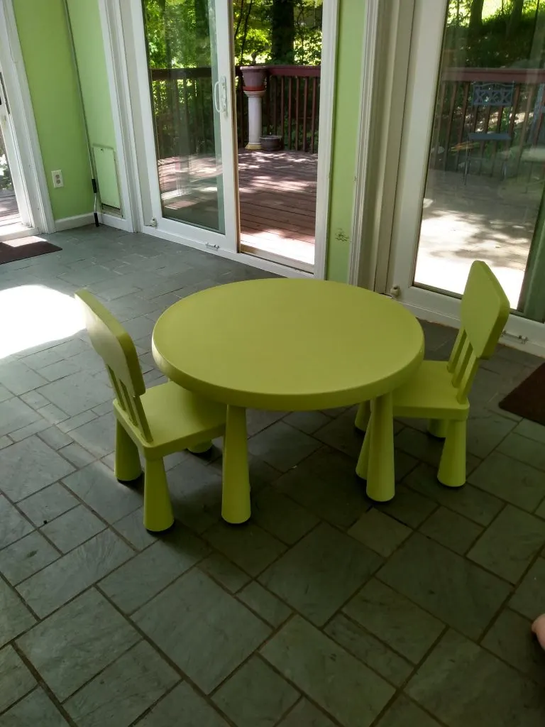 Kids sized ikea kids table in empty Montessori playroom.