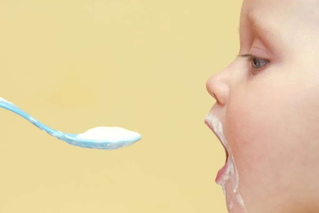 Baby being spoon fed.