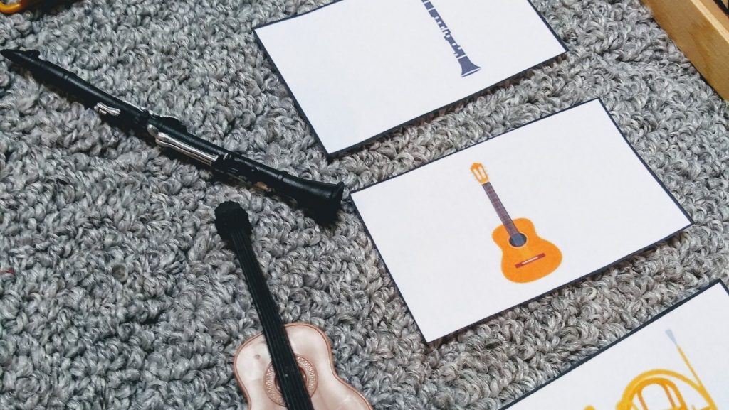 3 part cards and small musical instruments for musical instrument games for toddlers.