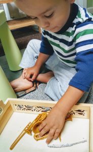 child exploring minature musical instruments