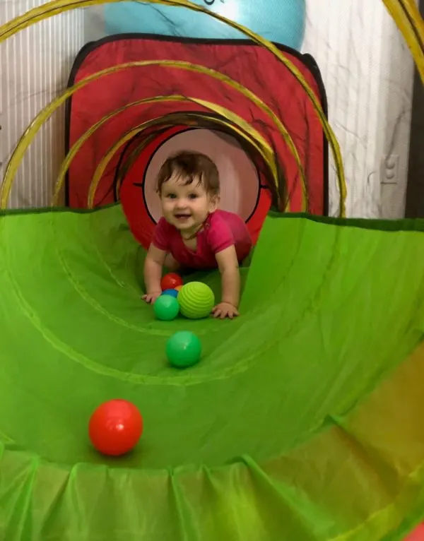 Baby crawling through tunnel