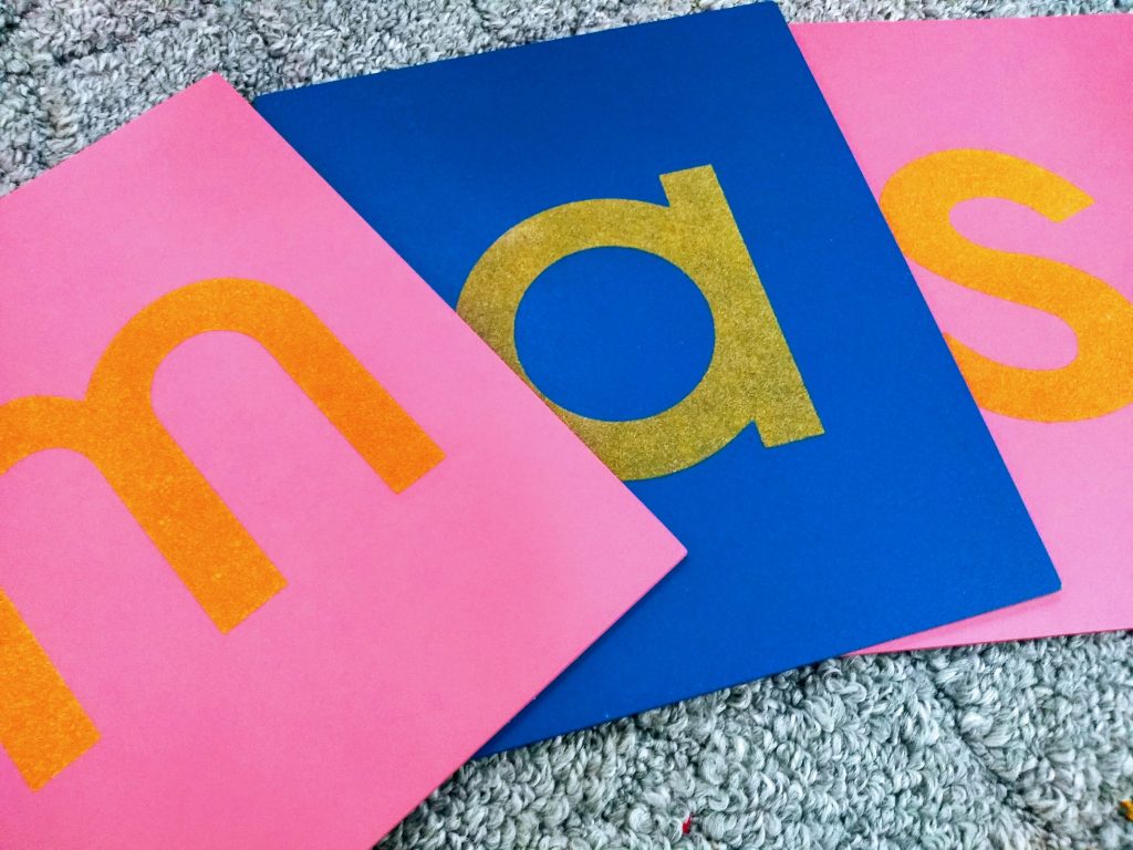 how do Sandpaper Letters work? close up photo of sandpaper letters.