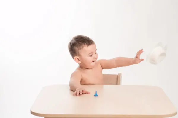 Baby throwing plastic bowl, demonstrating the lack of control of error in plastic-wear.