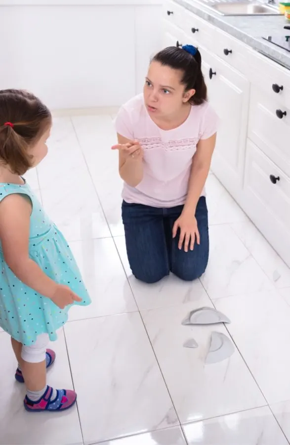 A child being punished for breaking a dish.