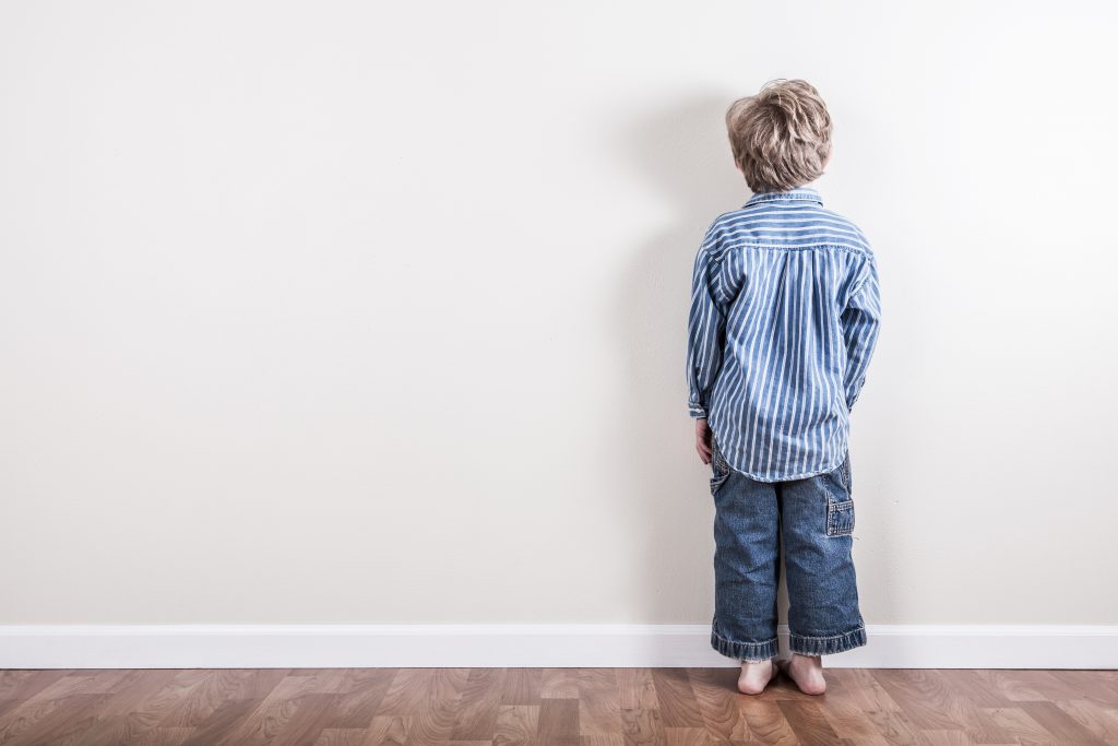 child in time-out facing wall, natural consequences vs. punishment.