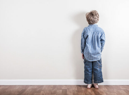 child in time-out facing wall, natural consequences vs. punishment.