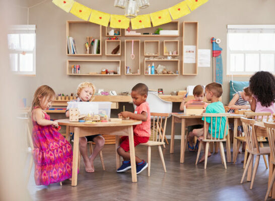 children working obediently in a prepared environment Montessori classroom.
