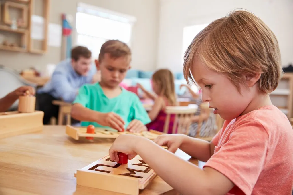 children in classroom "working" during their 3-6 planes of development.