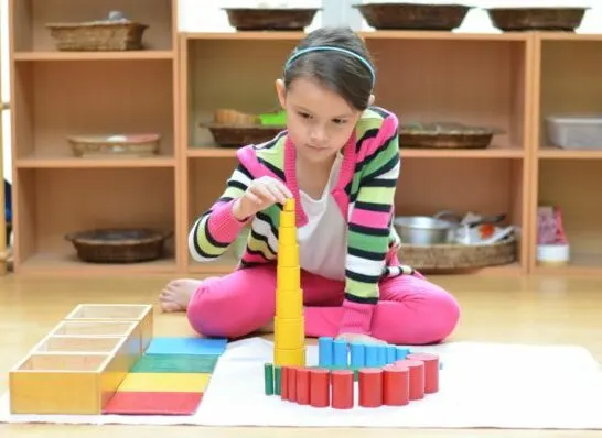 child working in the prepared environment of a Montessori classroom.