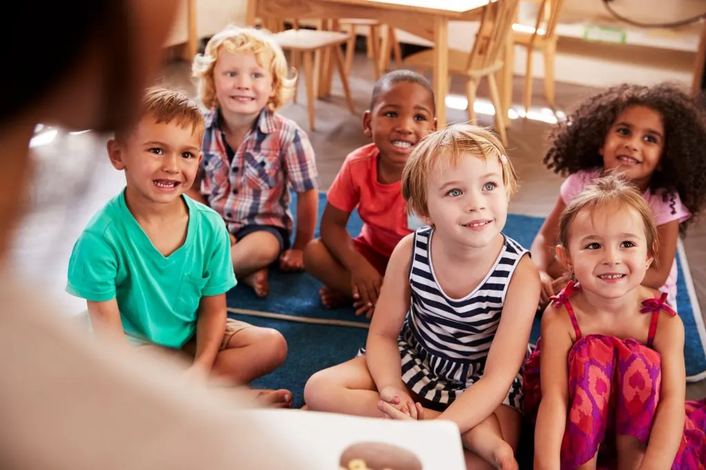 Children listen in a group.