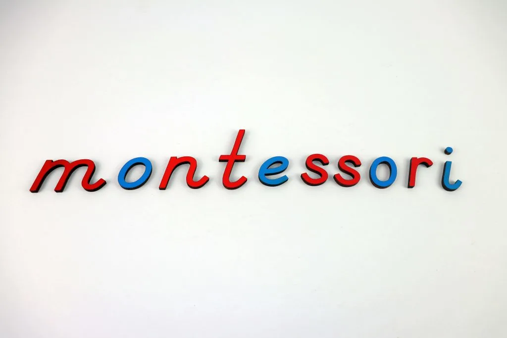 montessori spelled out using montessori blue and red cursive letters