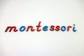 How To Montessori Homeschool: image of montessori spelled out using montessori blue and red cursive letters.