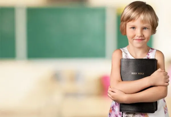 Child holding Bible