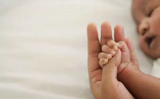 montessori for infants header image. mother holding infant's hand.