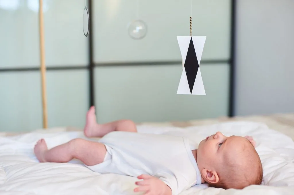 Montessori with babies: baby looking at montessori mobile.