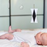 Montessori with babies: baby looking at montessori mobile.