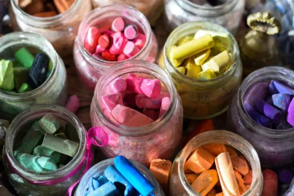 Colored crayons in glass jar. Waldorf schools are very much Montessori-like schools.