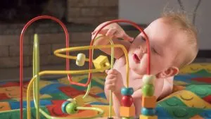 Baby playing with bead toy