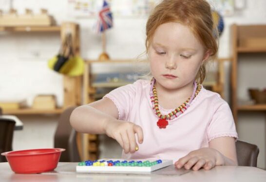 Montessori vs. daycare, image of child working in montessori class.