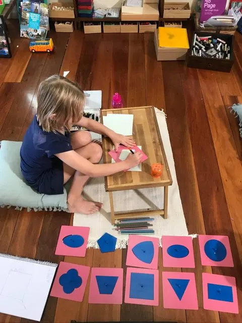 child using Montessori metal insets