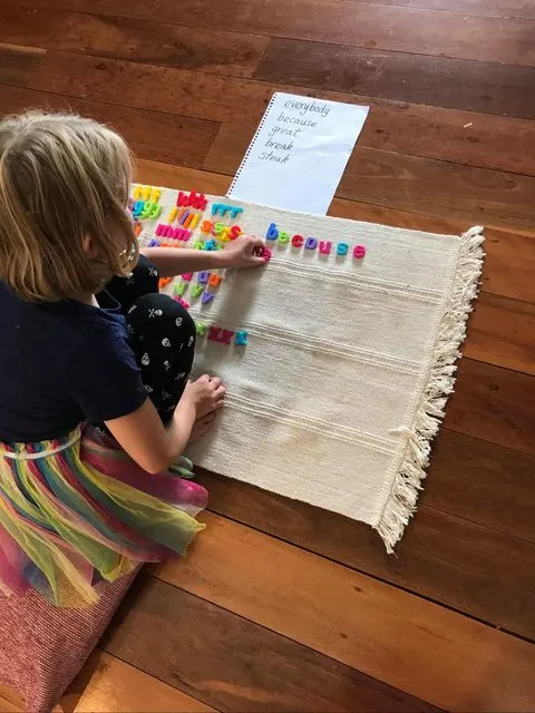 special needs child using Montessori movable alphabet