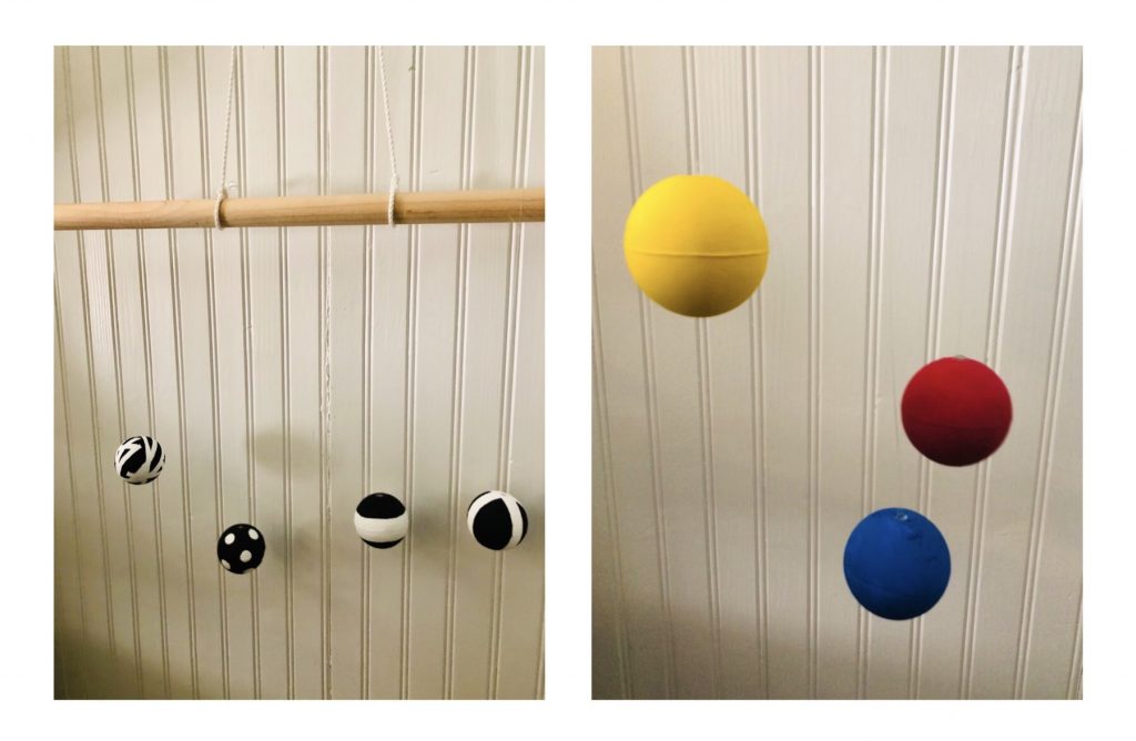 DIY Montessori baby mobile: black and white balls on left and image of yellow, red and blue on right.