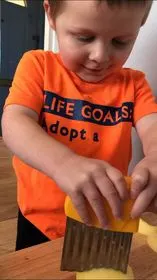 Toddler using knife. Montessori cooking with toddlers.