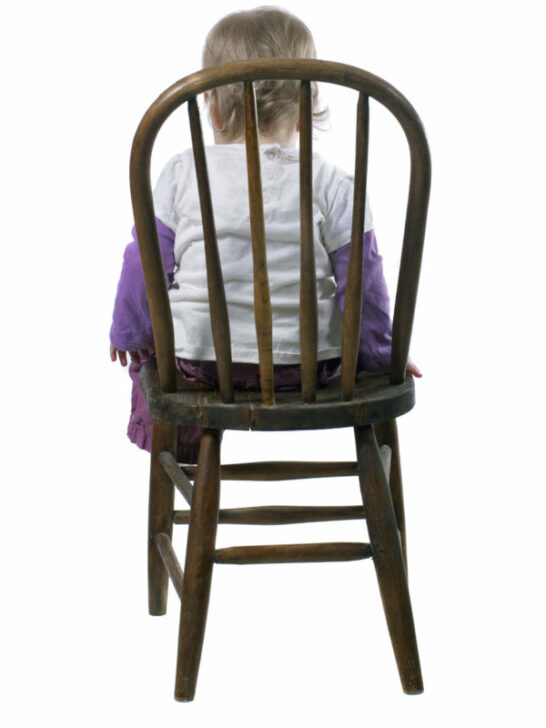 What is a time-in image of child sitting in chair.