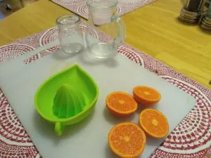 oranges and glasses for making hand squeezed juice.